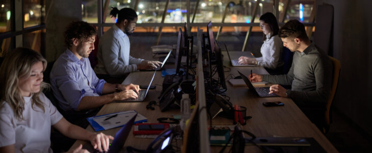 Group of entrepreneurs working on computers late in the office.