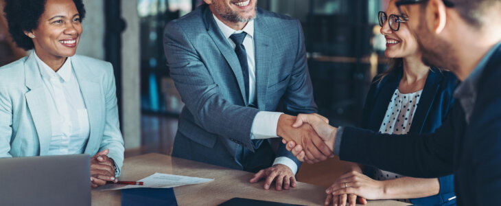 Two businessmen shaking hands in the office