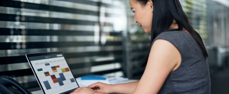 Shot of a young businesswoman using a laptop at her desk in a modern office