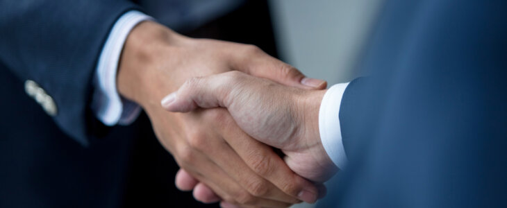Close-up of two unrecognizable business people shaking hands