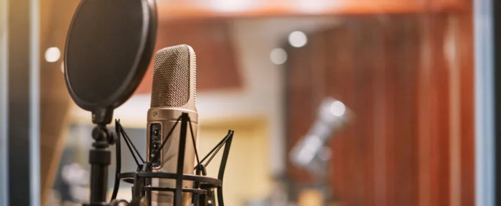 Microphone, studio and music with equipment at a record label for recording audio or sound for the radio. Singing, creative and art with a mic in an empty room for live streaming or production