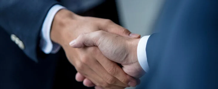 Close-up of two unrecognizable business people shaking hands